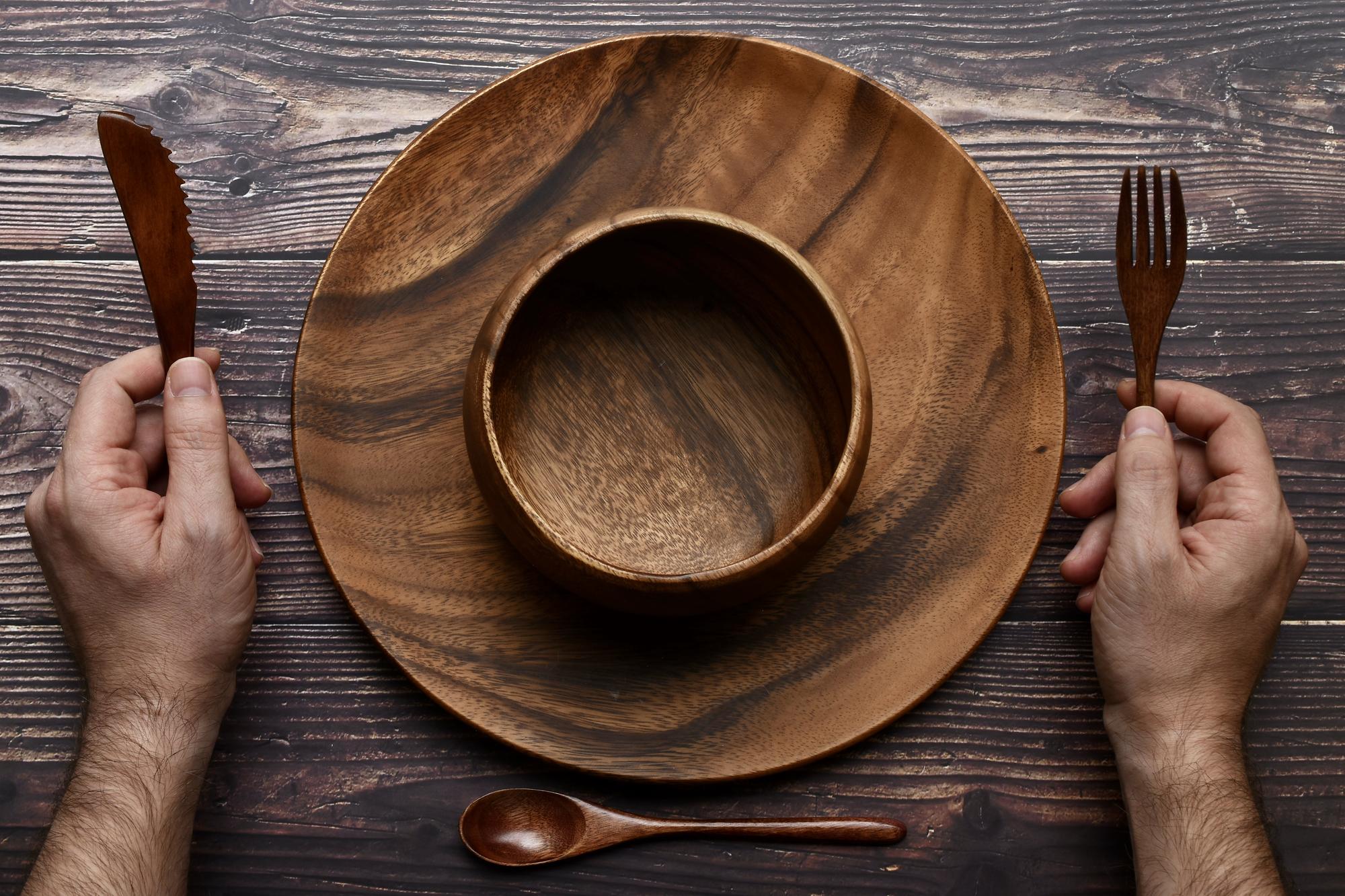 Chef arranging artisanal dish on wooden table